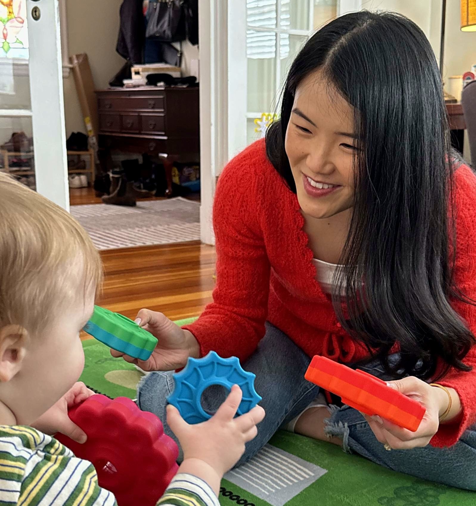 Dr. Jenny Li playing with a young child during an in-home session
